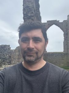 A photo of the author among the ruins of Lindisfarne Priory